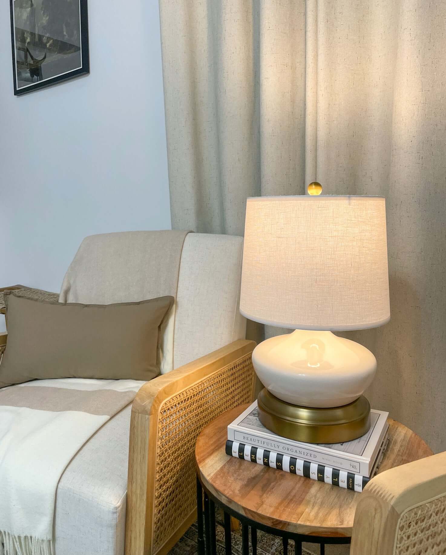 Ivory ceramic rechargeable lamp styled on a bedside table