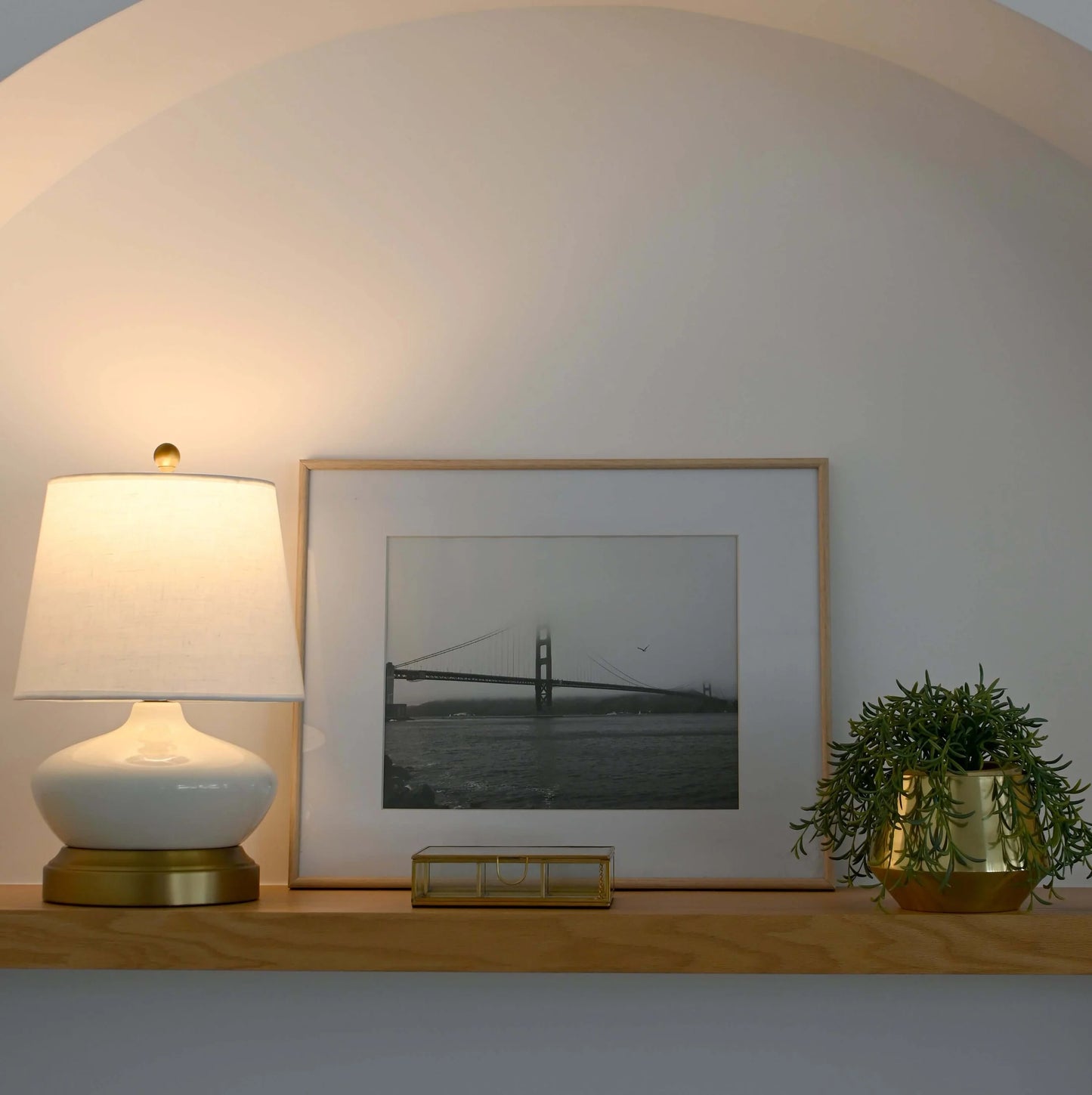 Portable LED table lamp with ivory ceramic body and brass accents