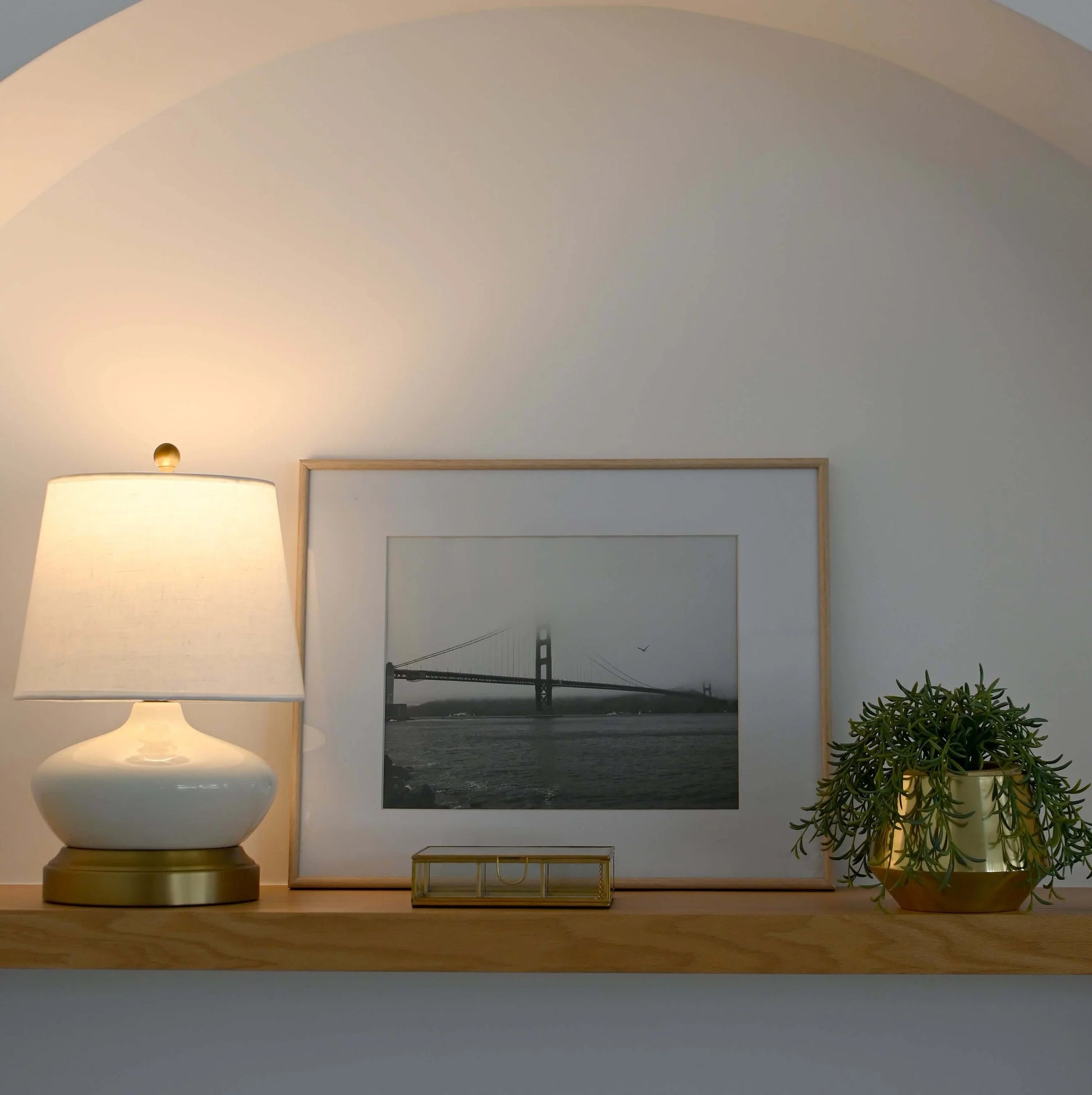 Portable LED table lamp with ivory ceramic body and brass accents