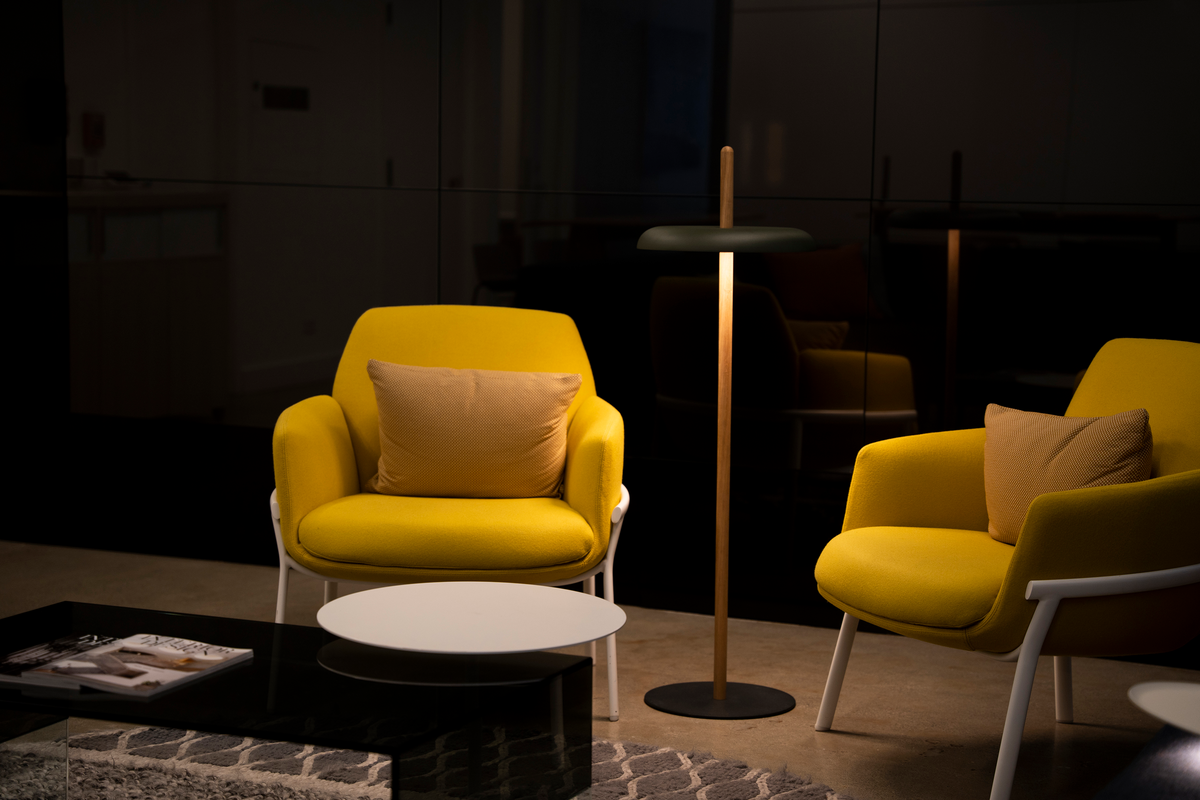 Cordless Nivél floor lamp beside a reading chair in a living room