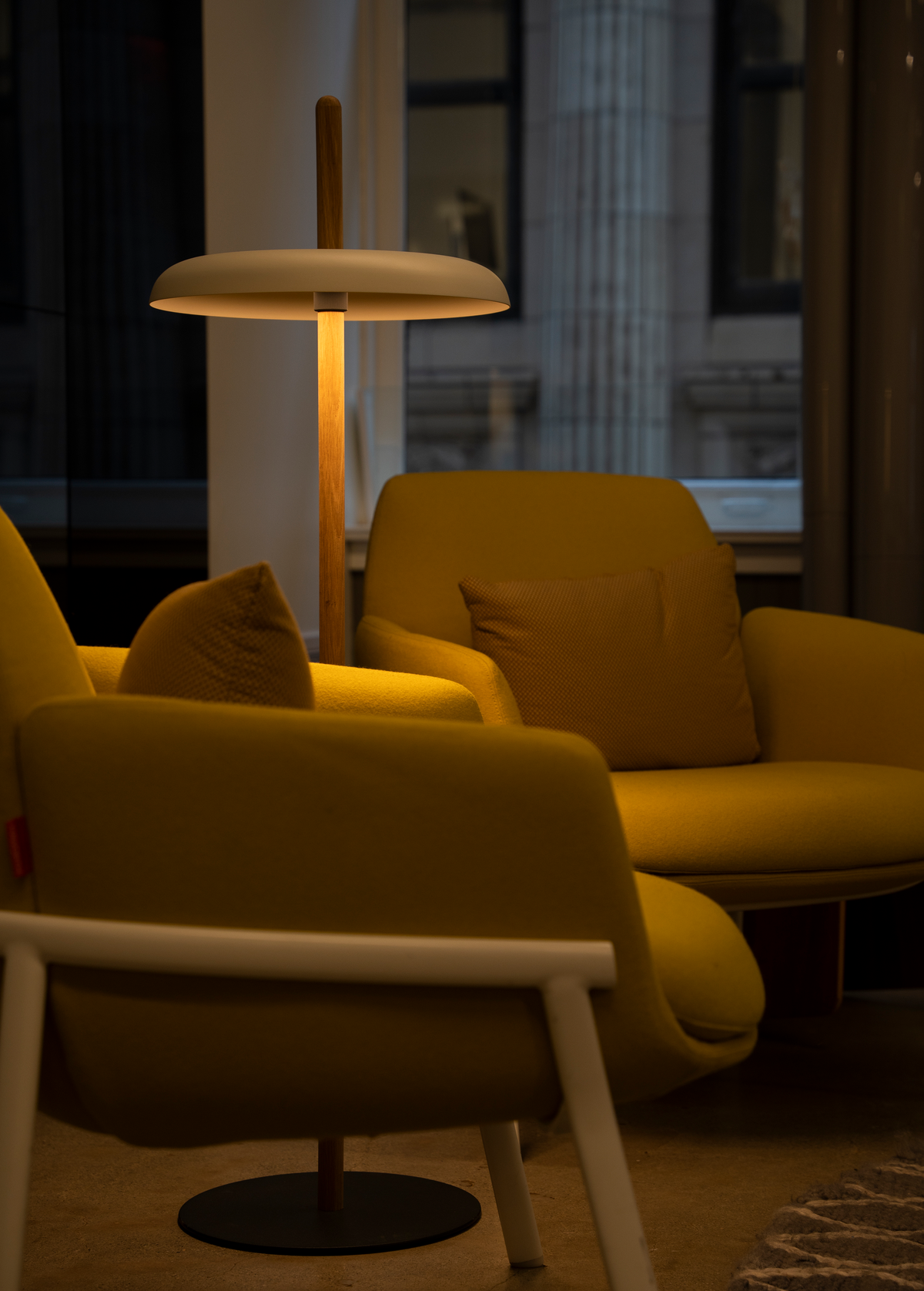 Nivél battery floor lamp lighting a corner of a room