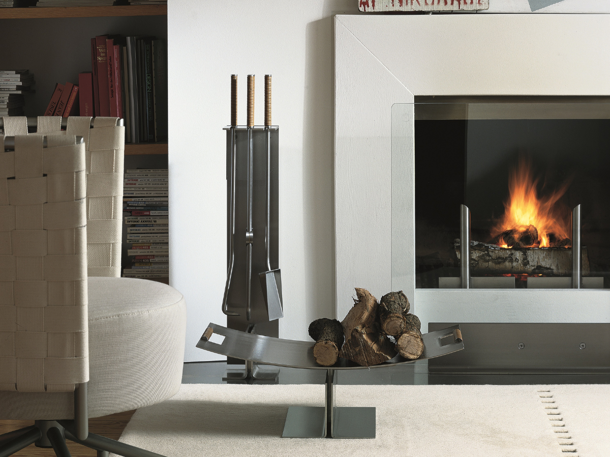 Peter Maly Fireside Tools with Floor Stand by Conmoto – next to an open fireplace with a log holder