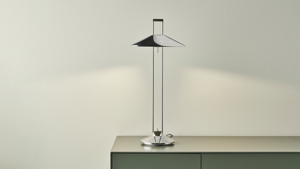 B.lux Regina T table lamp on a green sideboard with a conical shade