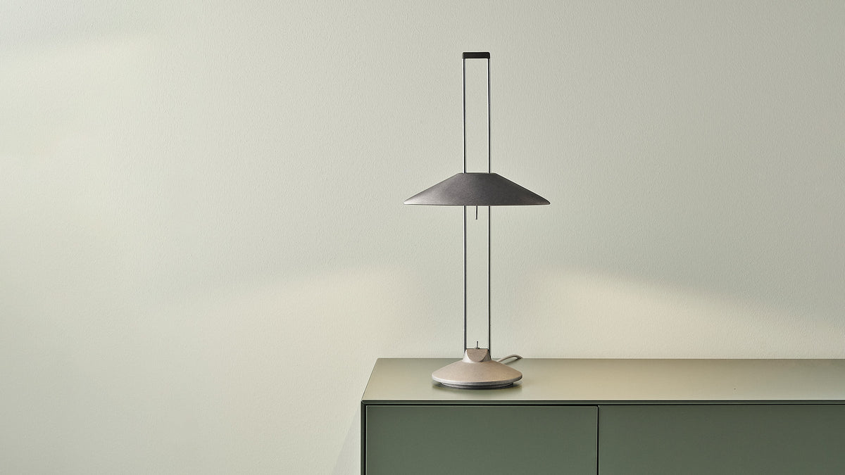 Regina T aluminium lamp with an indirect-light shade on a sideboard