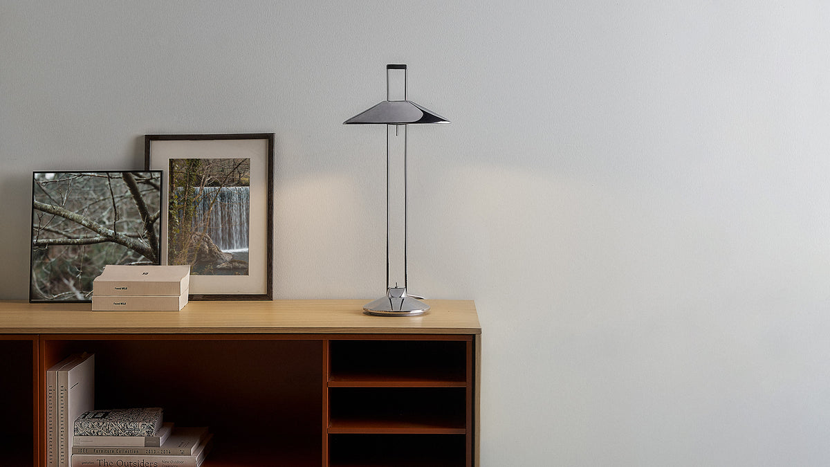 Regina T desk lamp styled with framed artwork and shelves