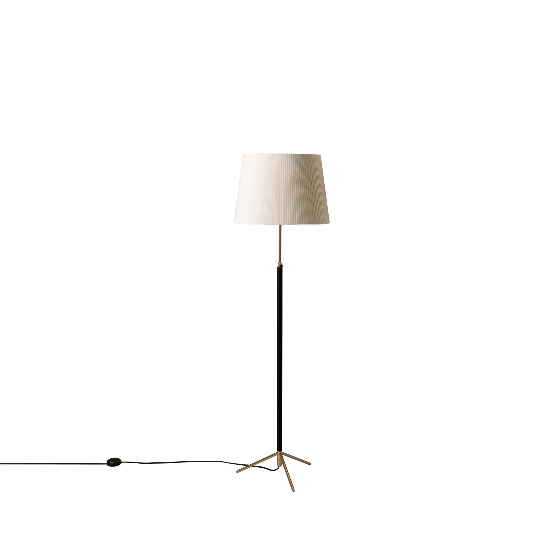 Adjustable height Santa & Cole Pie de Salon G1 lamp positioned beside reading chair