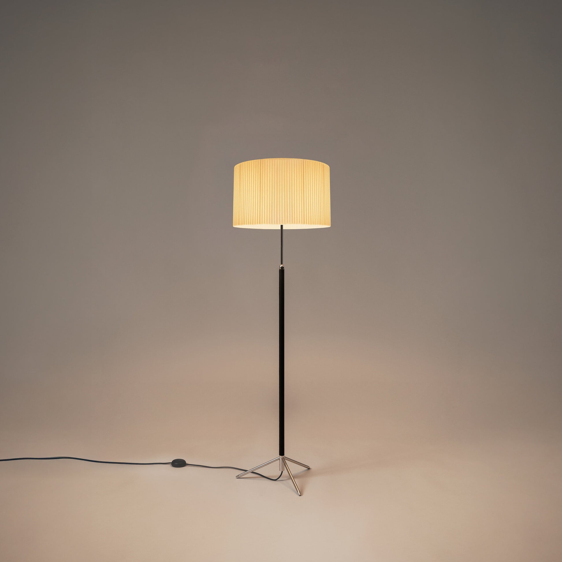 Modern floor lamp with leather-wrapped stem and chrome accents