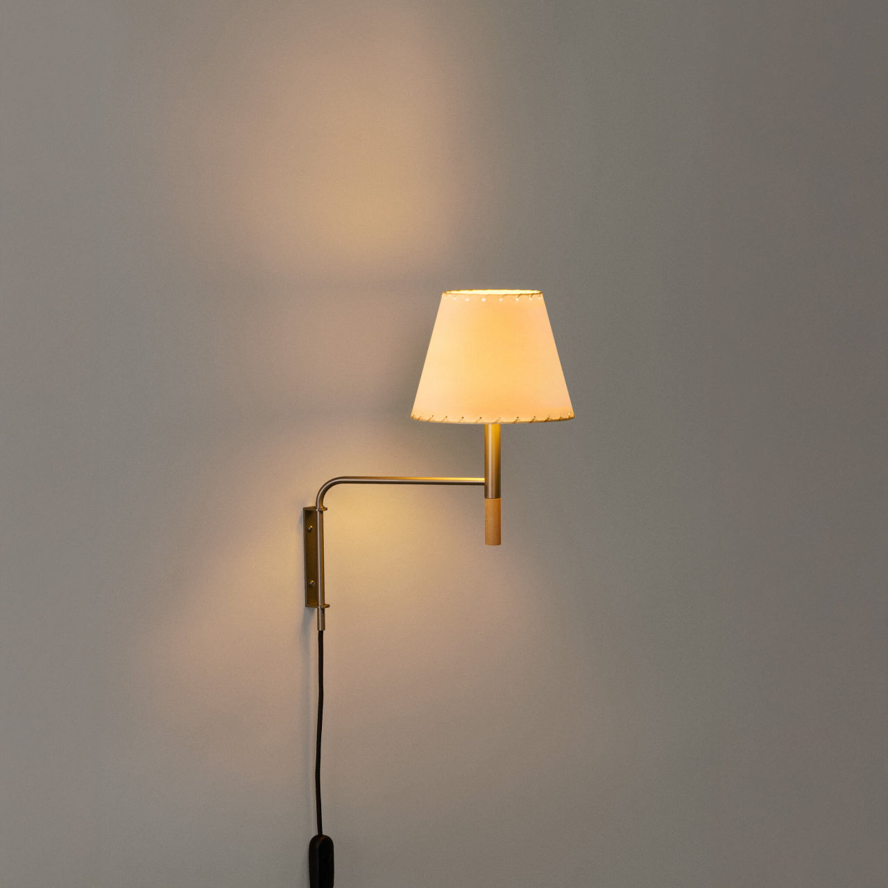 Plug-in BC Swing Aram wall lamp with stitched beige parchment shade for luxury interior spaces