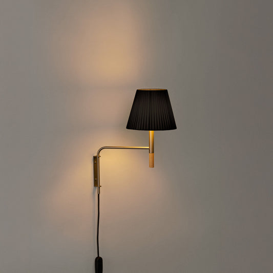 Plug-in BC wall lamp by Santa & Cole with black ribbon shade for luxury residential and hospitality spaces