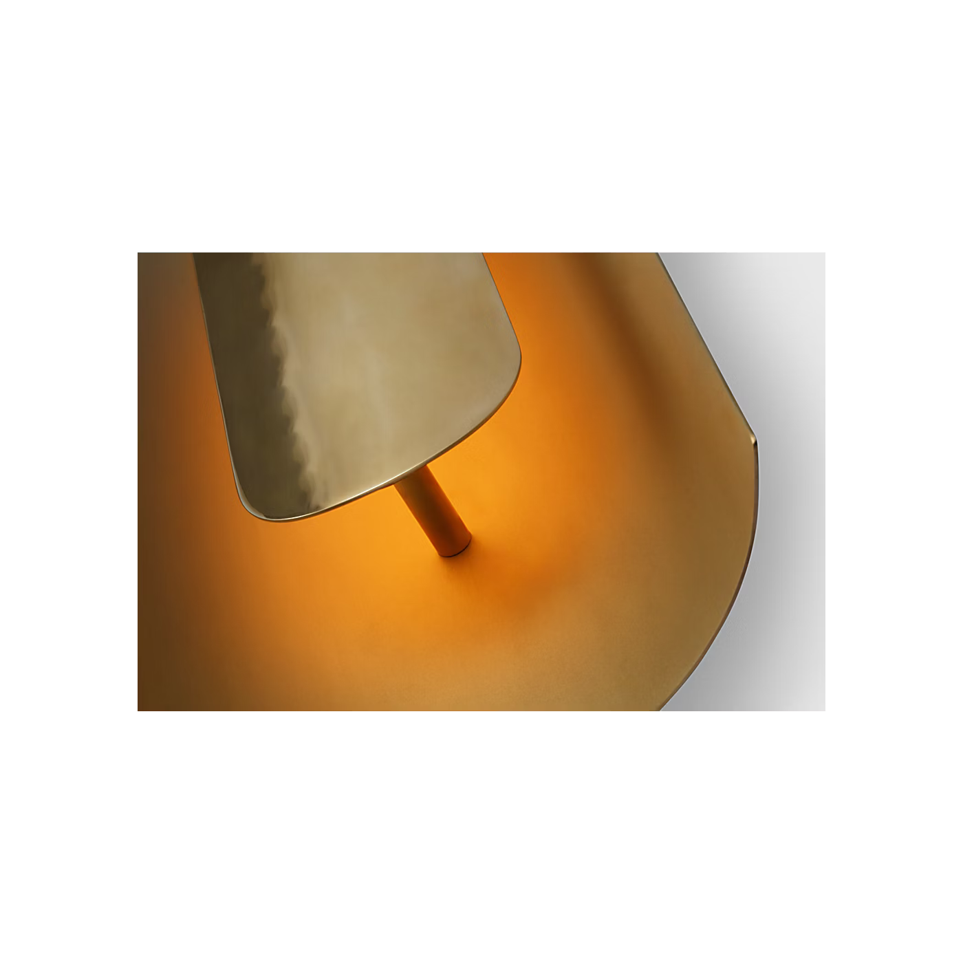 Brass wall sconce mounted vertically in contemporary hallway design
