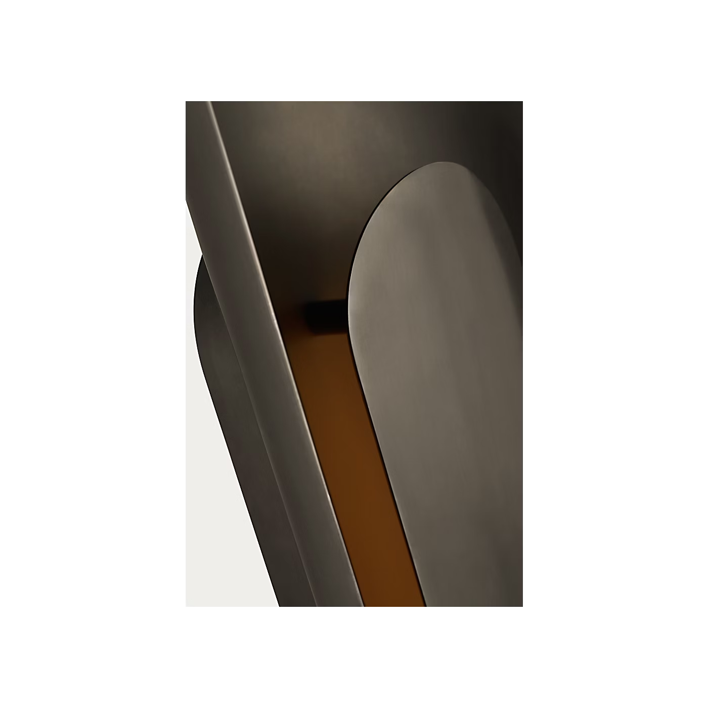 Bronze wall sconce mounted vertically in contemporary hallway interior