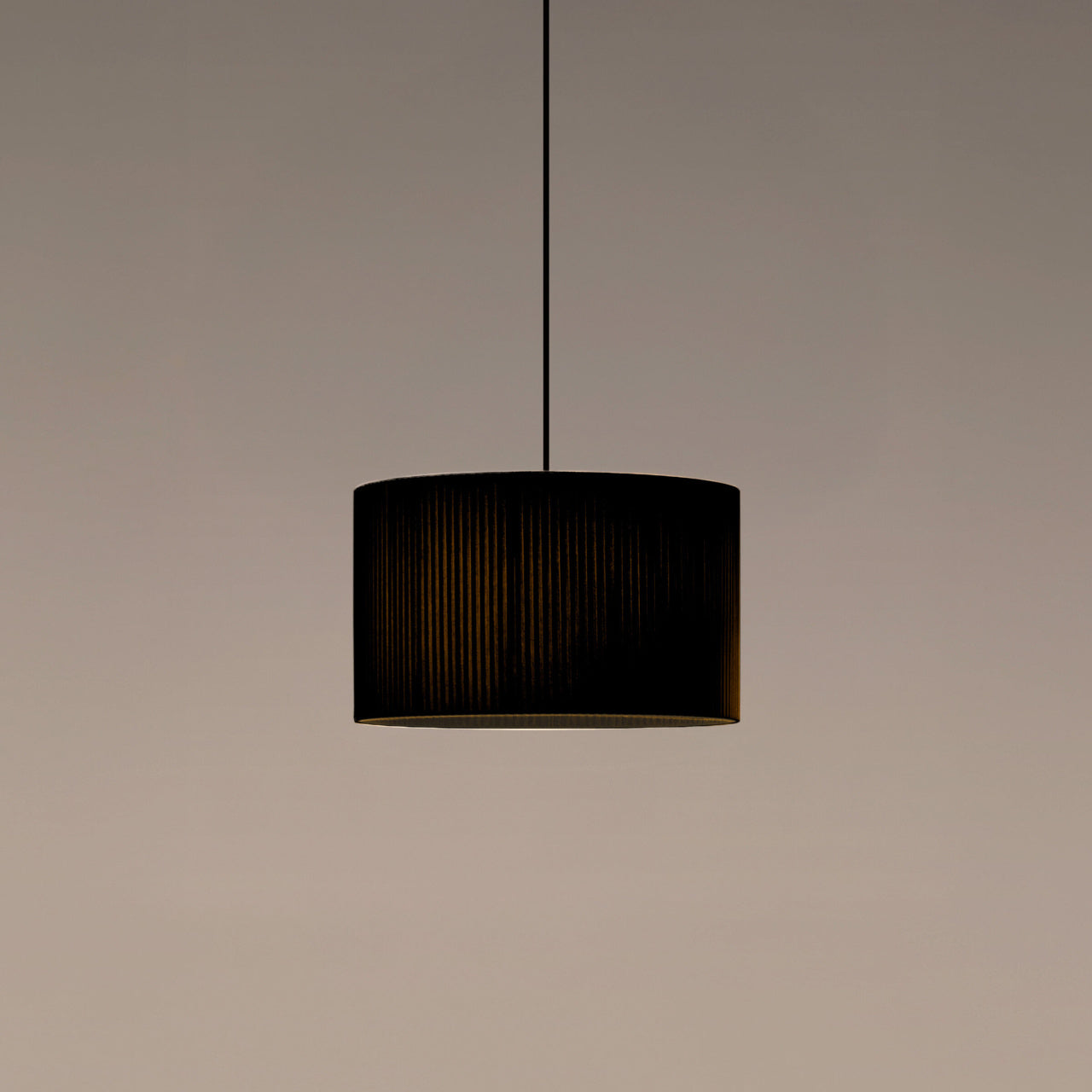 Modern cylindrical pendant light with black ribbon shade by Santa & Cole for dining rooms and kitchens
