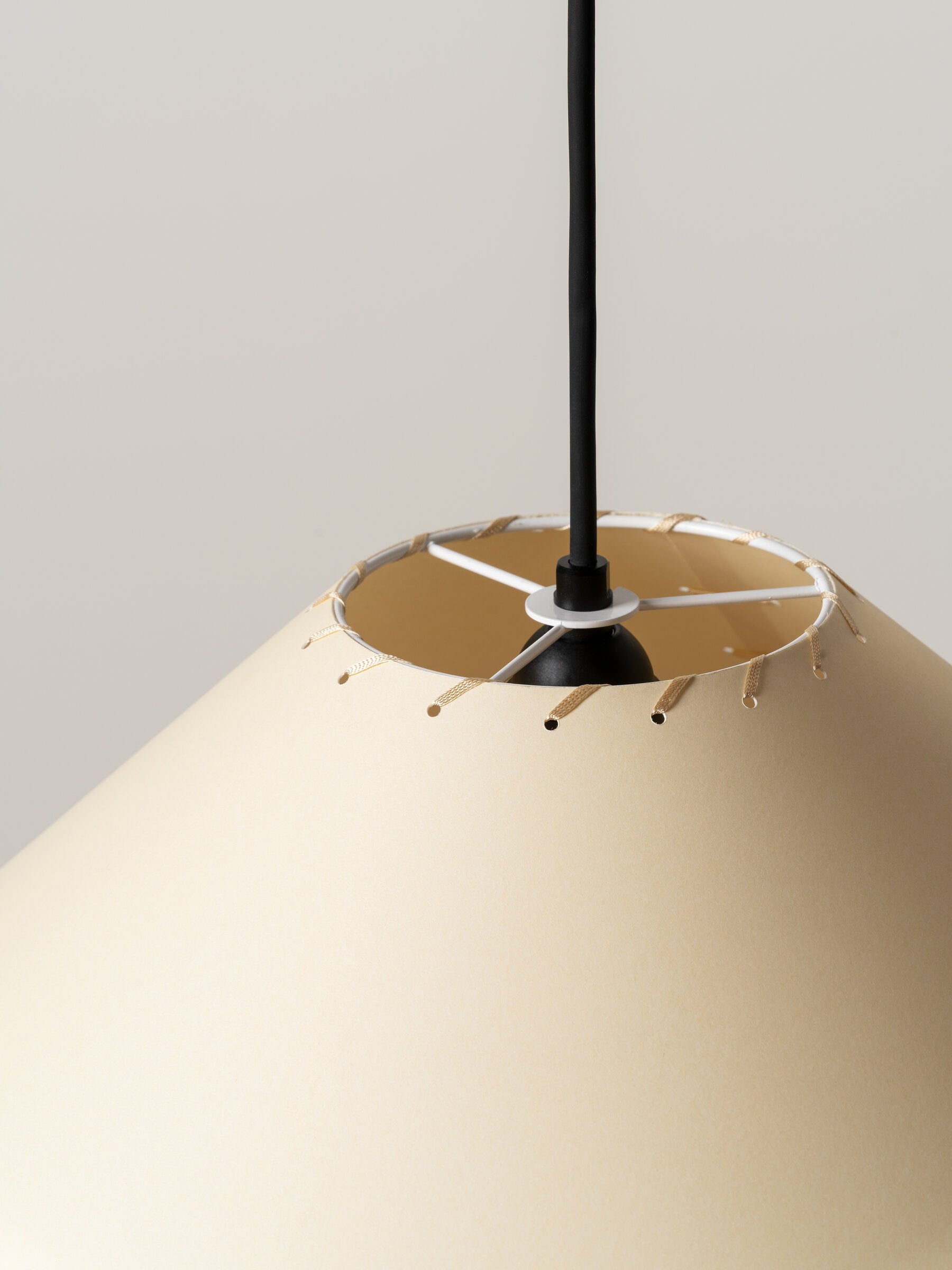 Beige stitched parchment conical pendant light close up