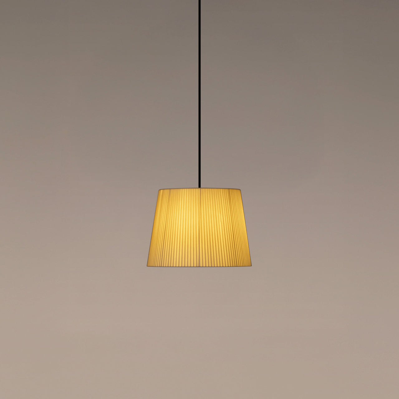 Santa & Cole GT3 pendant light with natural ribbon shade creating warm ambient lighting in a contemporary interior
