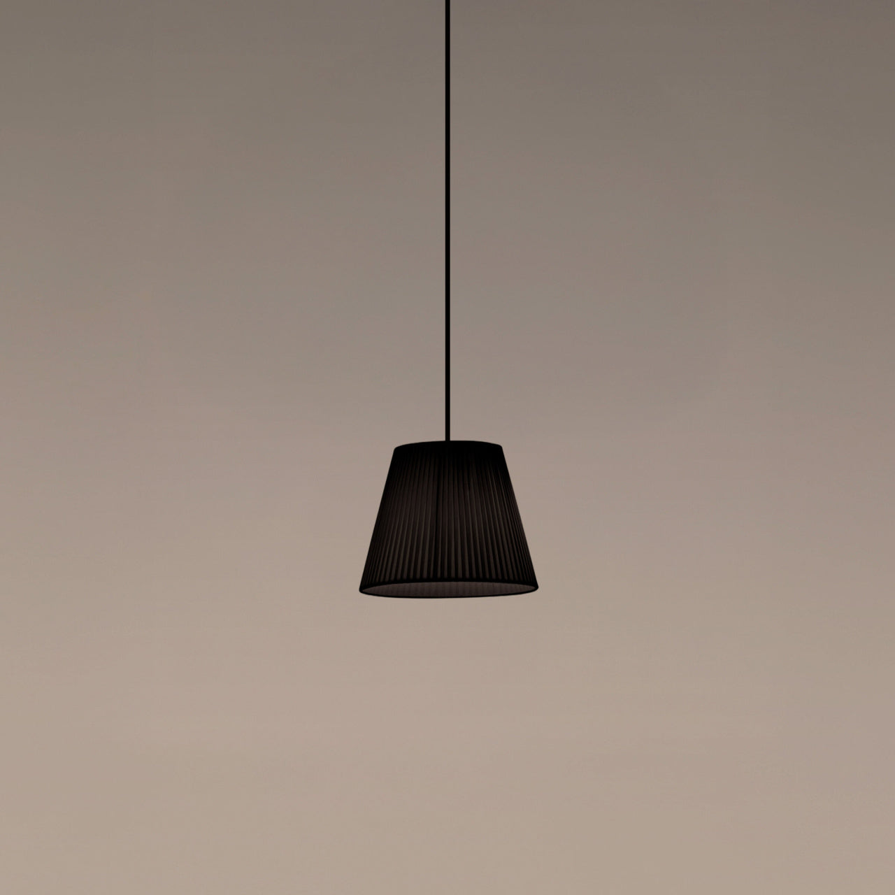 Santa & Cole MT1 pendant light with black ribbon shade providing warm ambient lighting in a modern interior