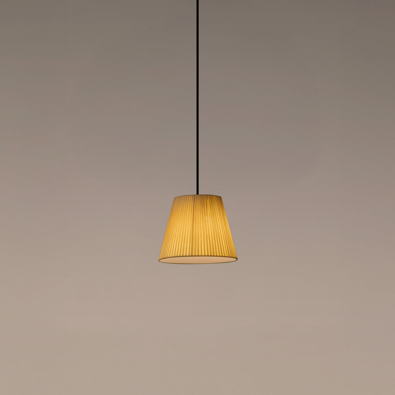 Santa & Cole MT1 pendant light with natural ribbon shade creating warm ambient lighting in a modern interior