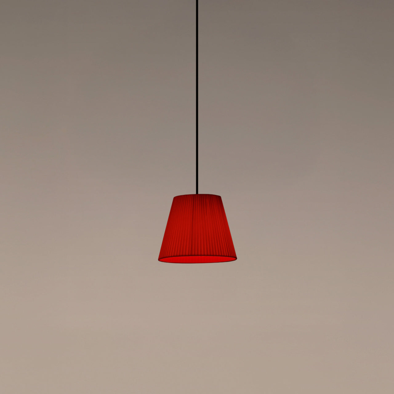 Santa & Cole MT1 pendant light with red-amber ribbon shade creating warm ambient lighting in a contemporary interior