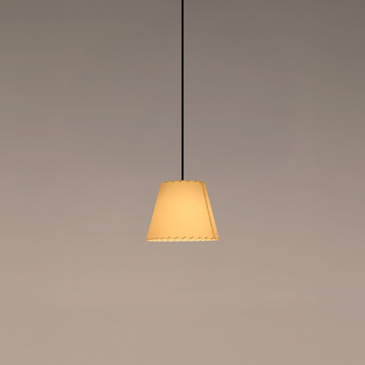 Santa & Cole Sísísí Cónicas MT1 pendant light with stitched beige parchment shade above a modern dining table