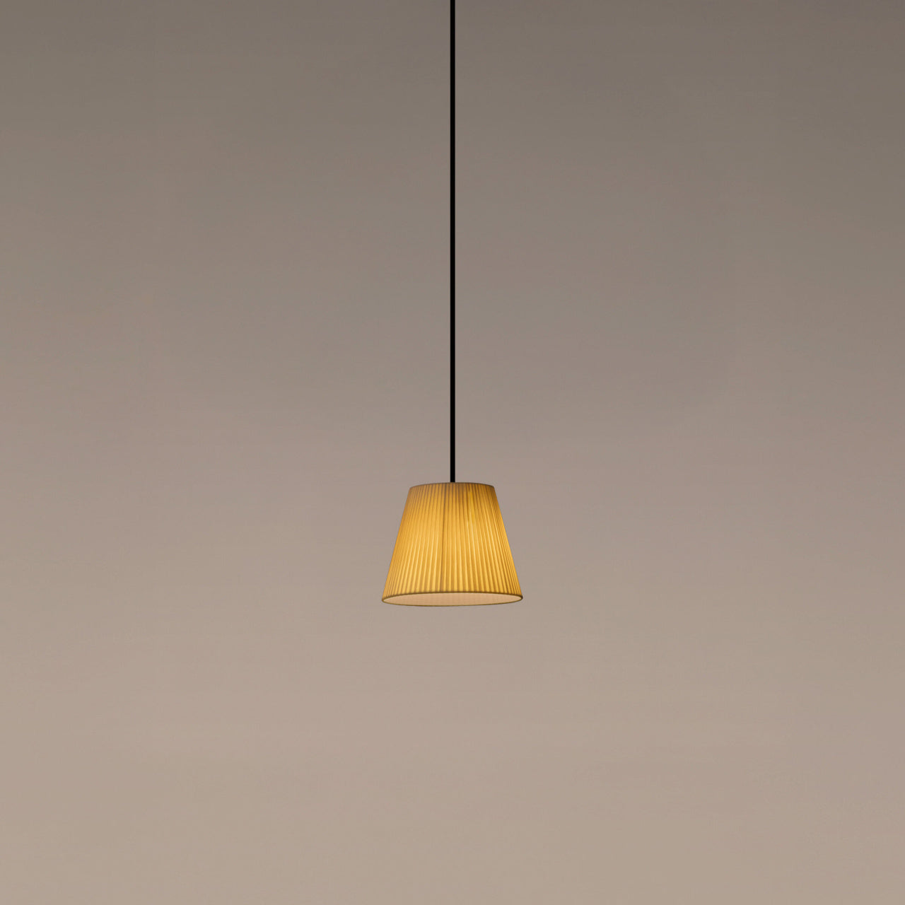 Natural ribbon Santa & Cole PT1 pendant light providing warm ambient illumination in a contemporary interior