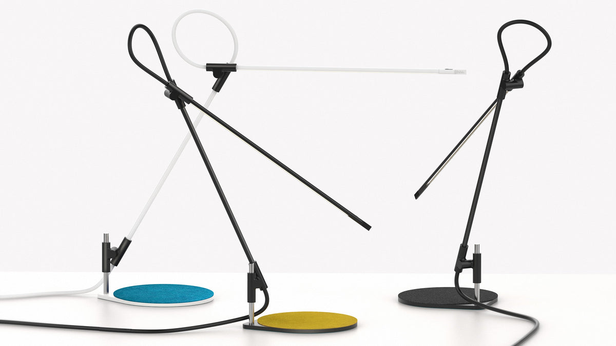 Pablo Designs Superlight table lamps in Black and White showing the turquoise, mustard and charcoal felt pads