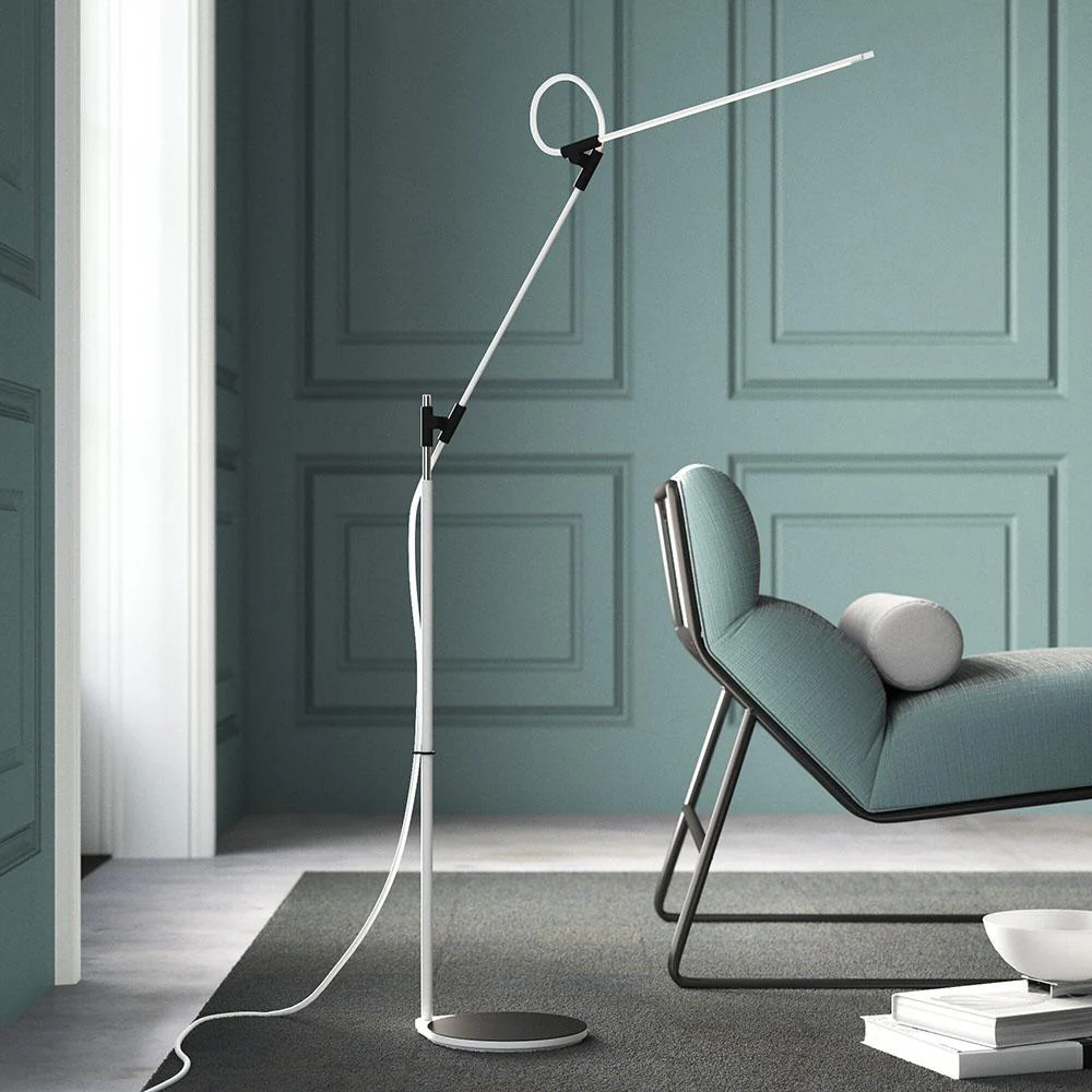 Slim articulating floor lamp beside a reading chair, view 1