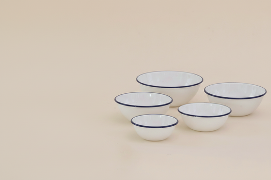 Tsukiusagi-jirushi Enamel Nesting Bowls, Set of 5, Navy Rim – set arranged on a wooden surface