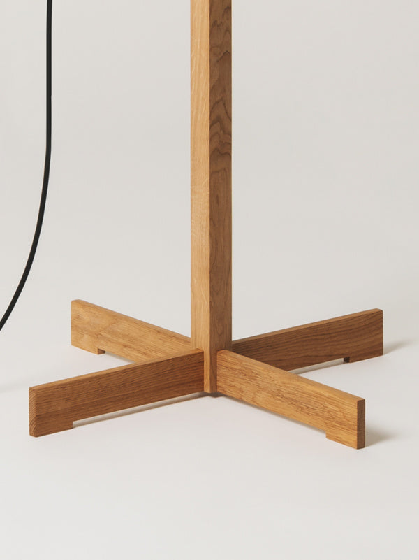 Elegant natural finish floor lamp by Santa & Cole designed for living rooms, bedrooms, and reception areas