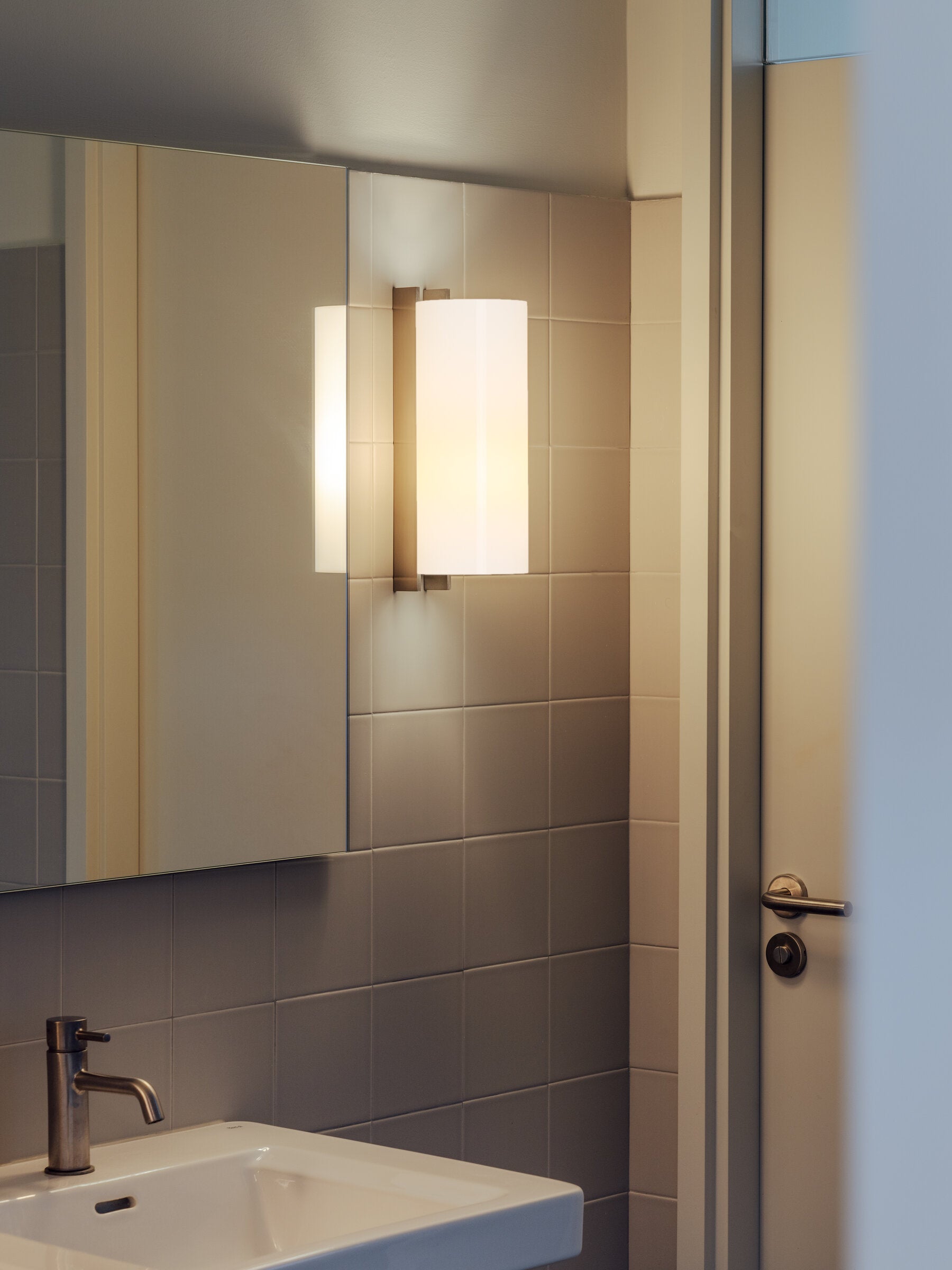 Satin nickel bathroom wall sconce with white diffuser