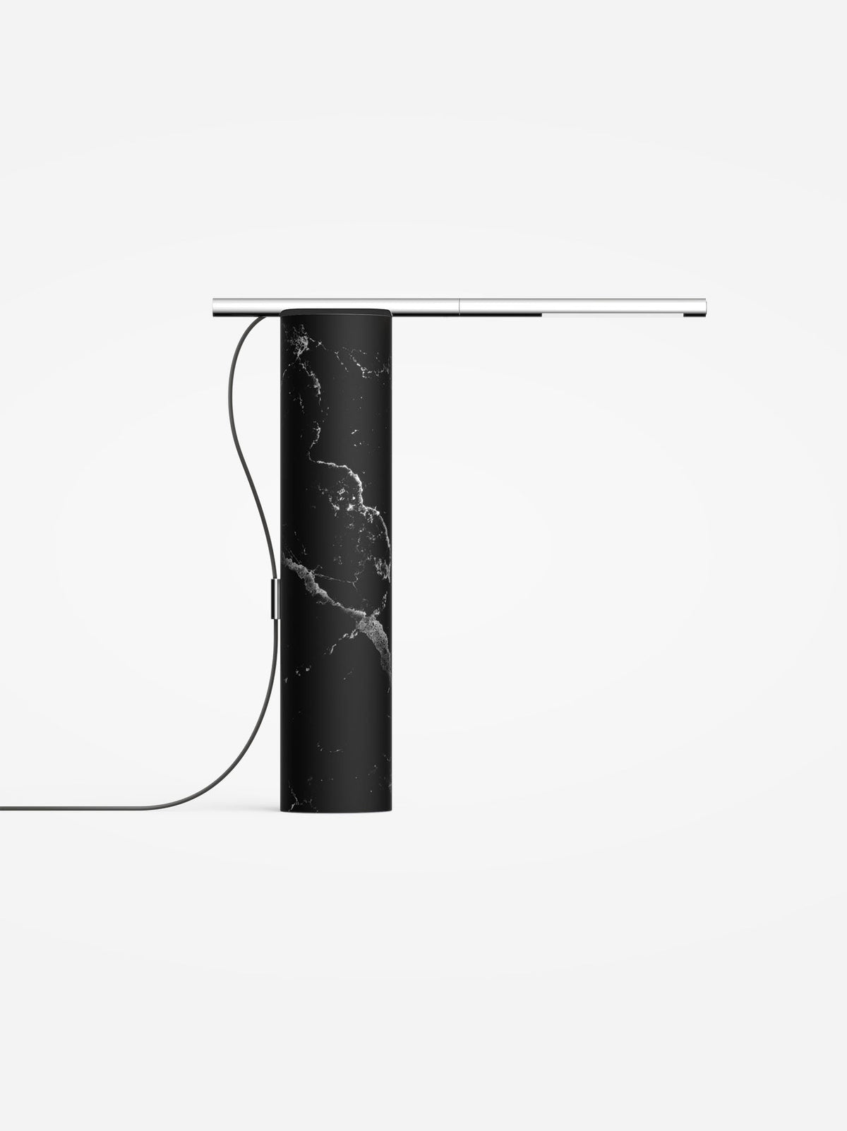 Marquina black marble base lamp with a chrome light arm, studio view