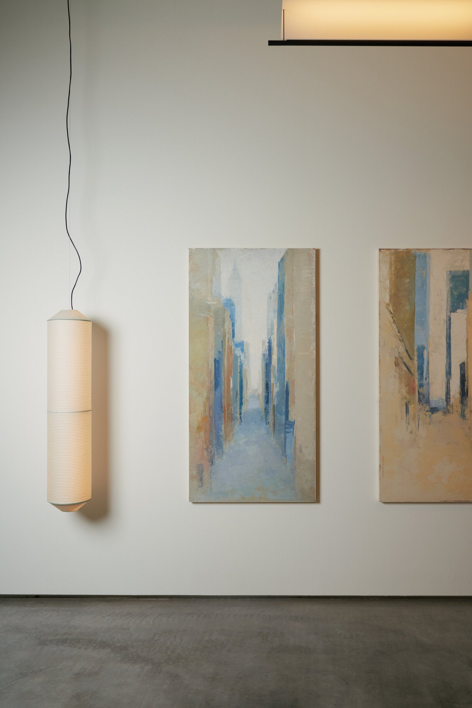 Large vertical pendant light for high ceiling interiors