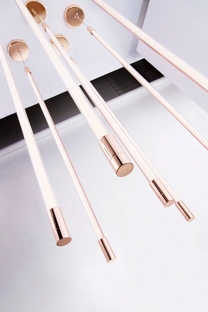 Thin LED linear suspension light by Viso in a lifestyle setting