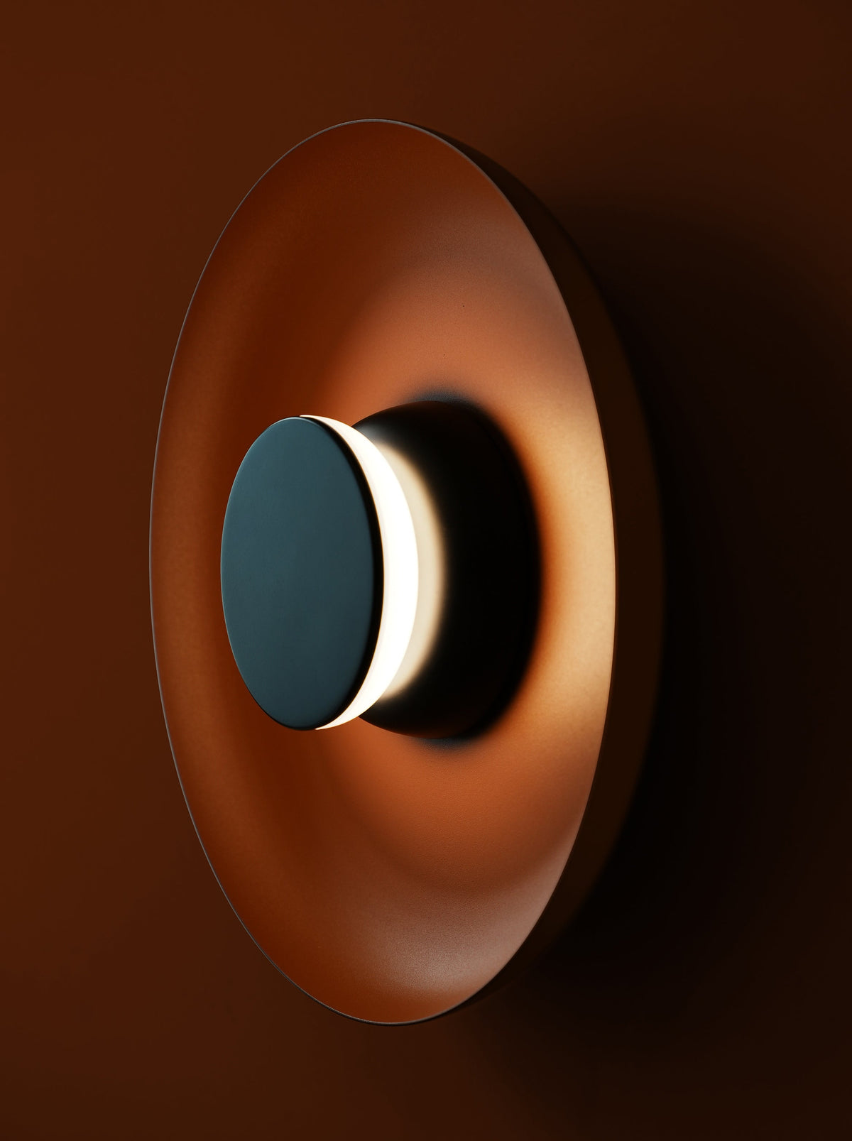 Totem metal shade wall sconces glowing on a bedroom wall
