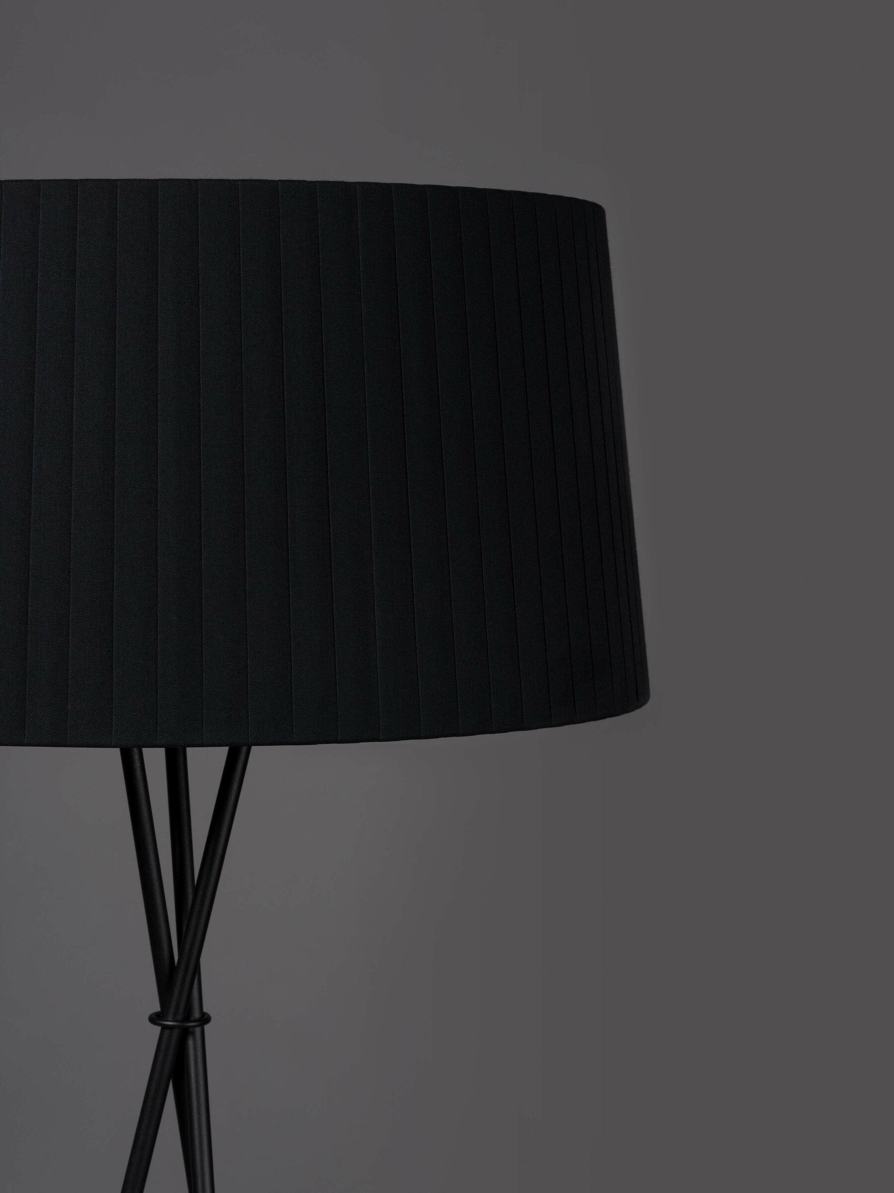 Santa and Cole black ribbon floor lamp with soft ambient lighting