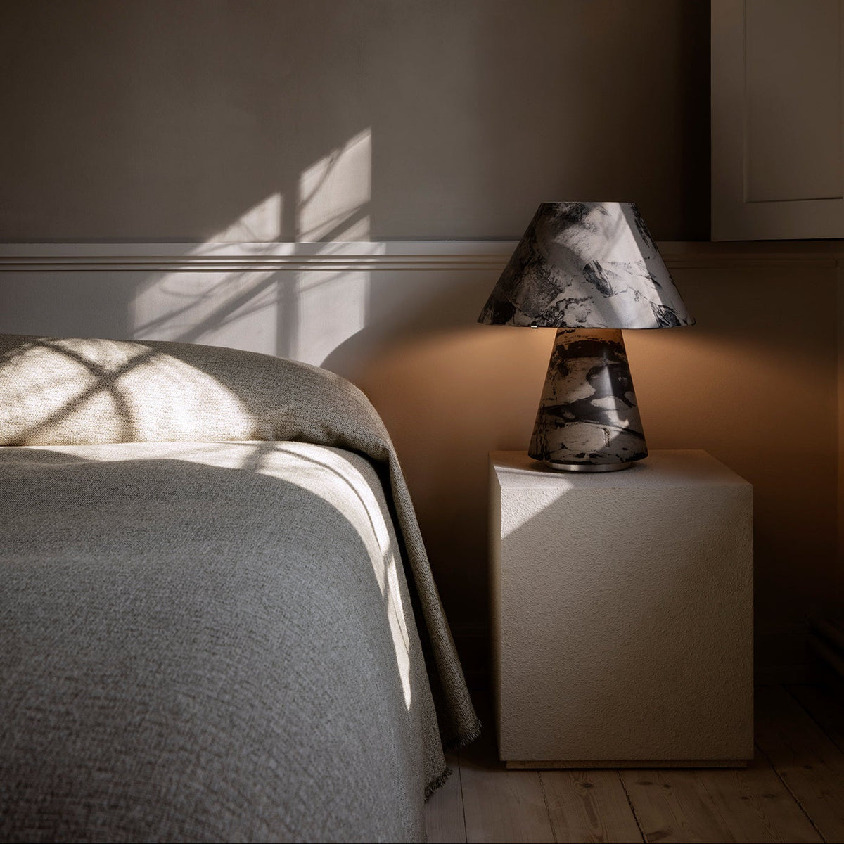 Upglas T2 by Astep — black version lit on a bedside table
