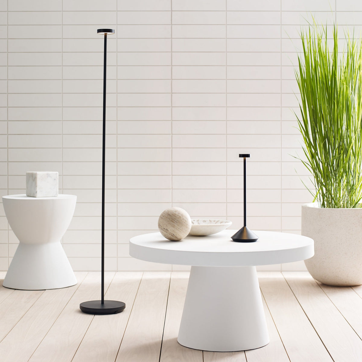 Moneta Medium floor lamp lit beside seating