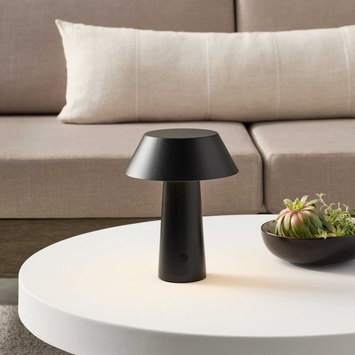 Sesa Short Accent cordless lamp in Black glowing on a table