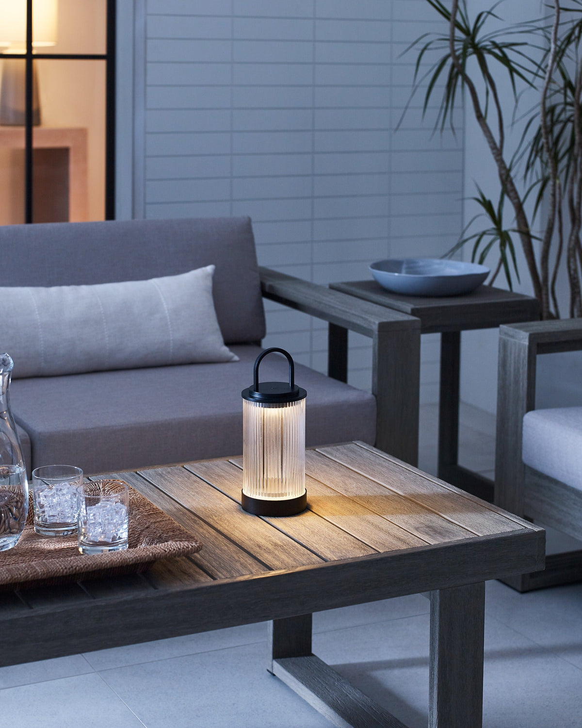 Tawa Accent cordless lamp in Black glowing on a table