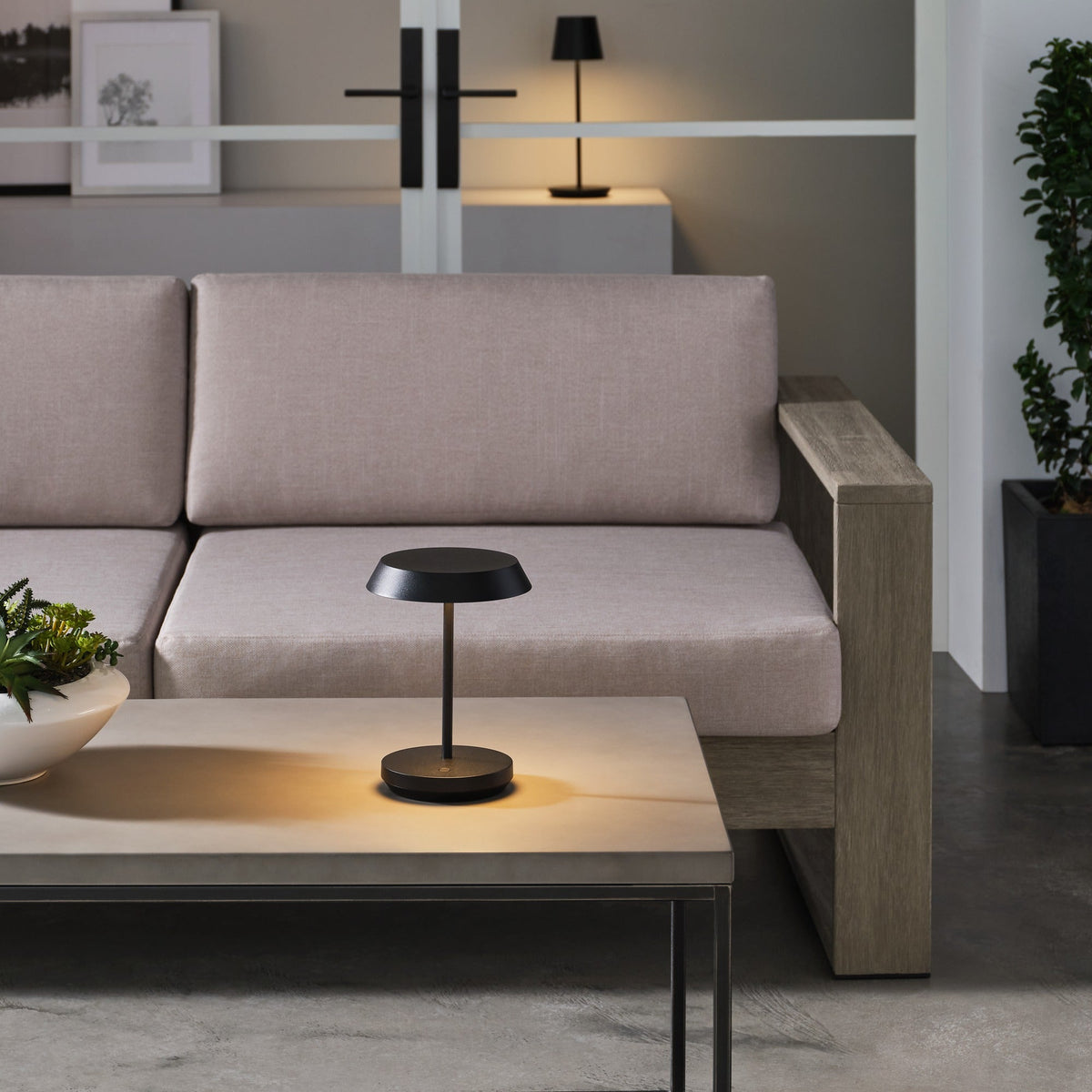 Tepa Short Accent cordless lamp in Black glowing on a table
