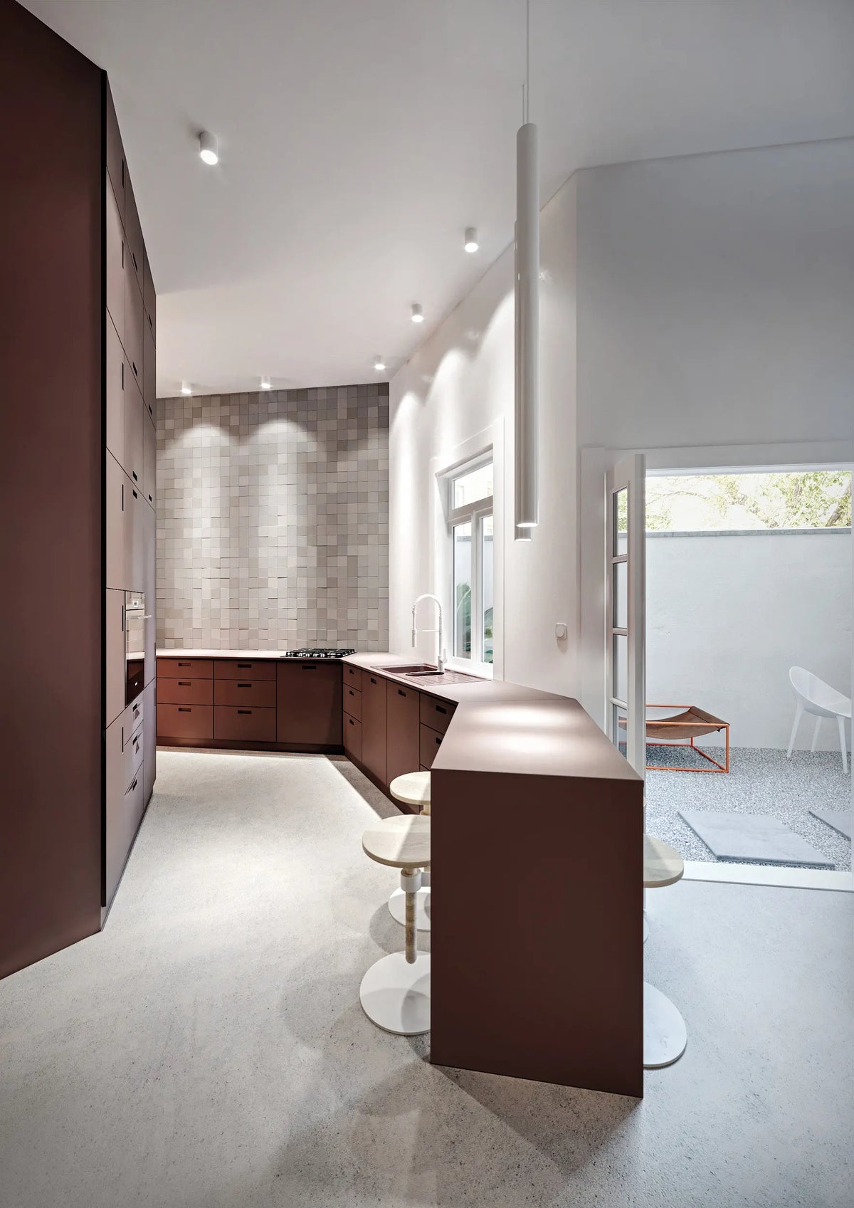 Modern Lodes A-Tube Linear Pendant Light suspended above a kitchen island