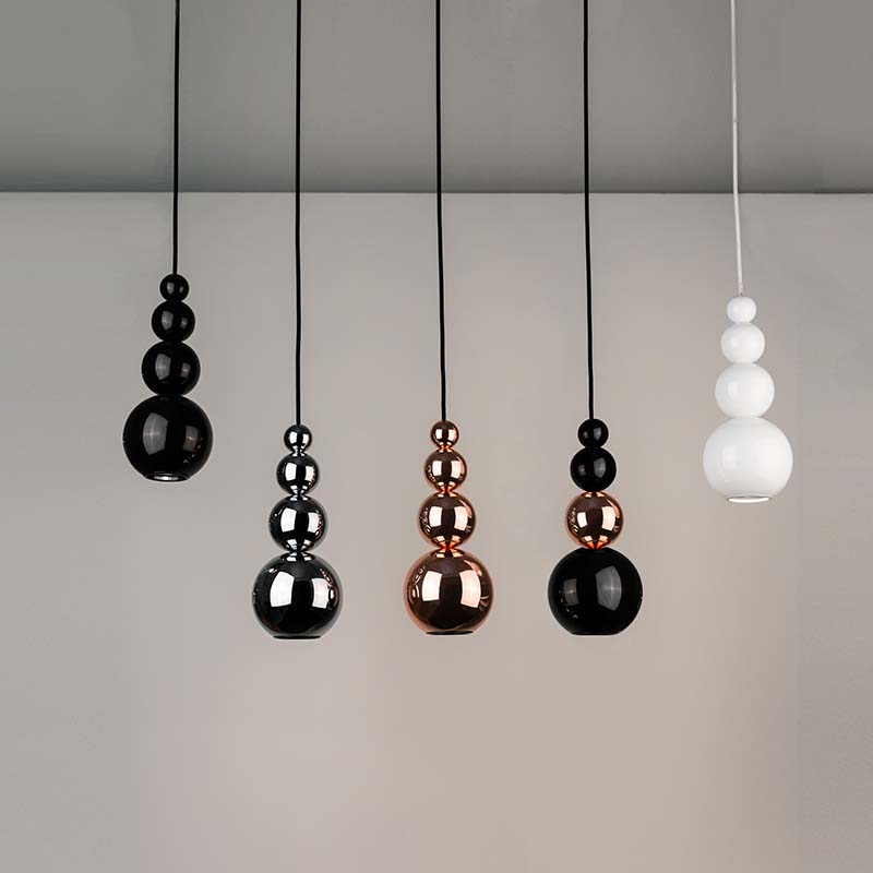 Minimalist white hanging light fixture inspired by contemporary jewelry design