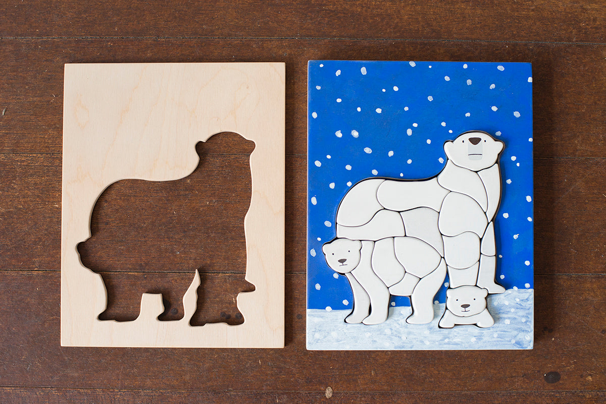 Eguchi Toys Polar Bear Puzzle – frame and finished puzzle on a wooden table