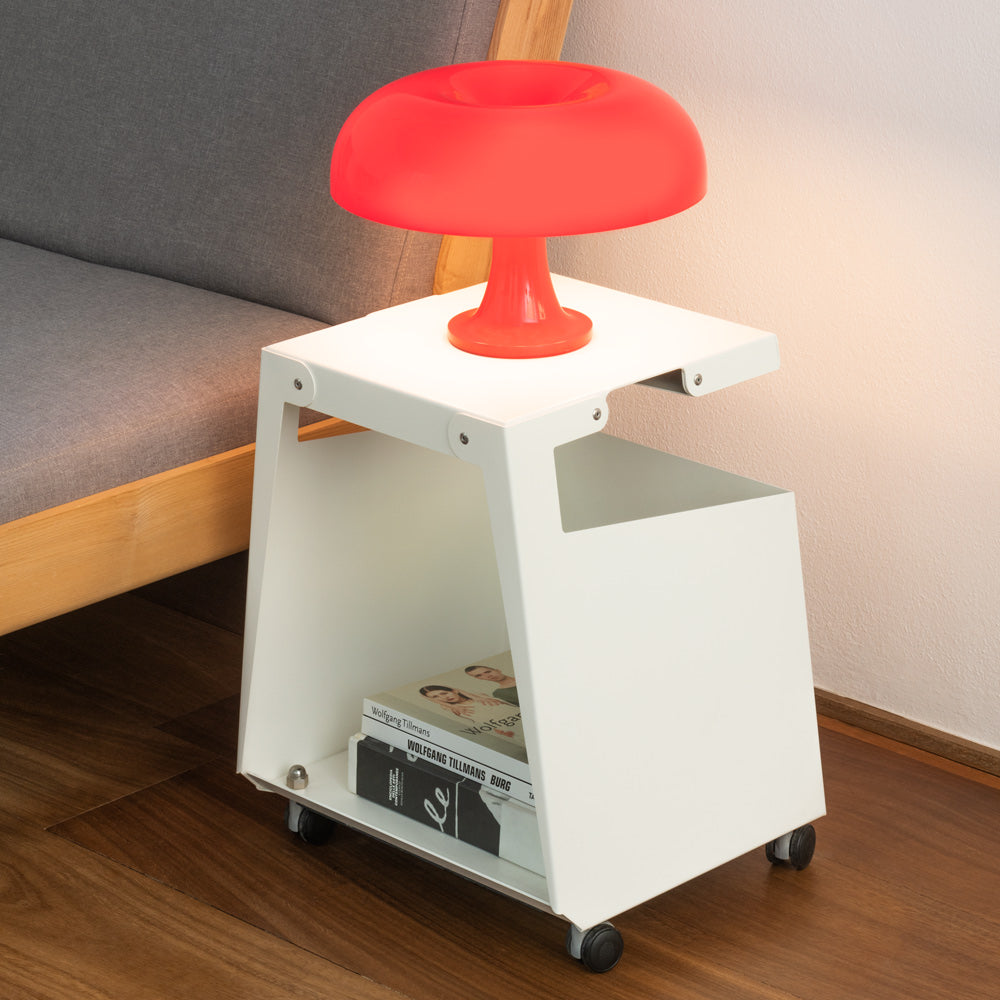Artemide Nessino mushroom table lamp on side table in orange