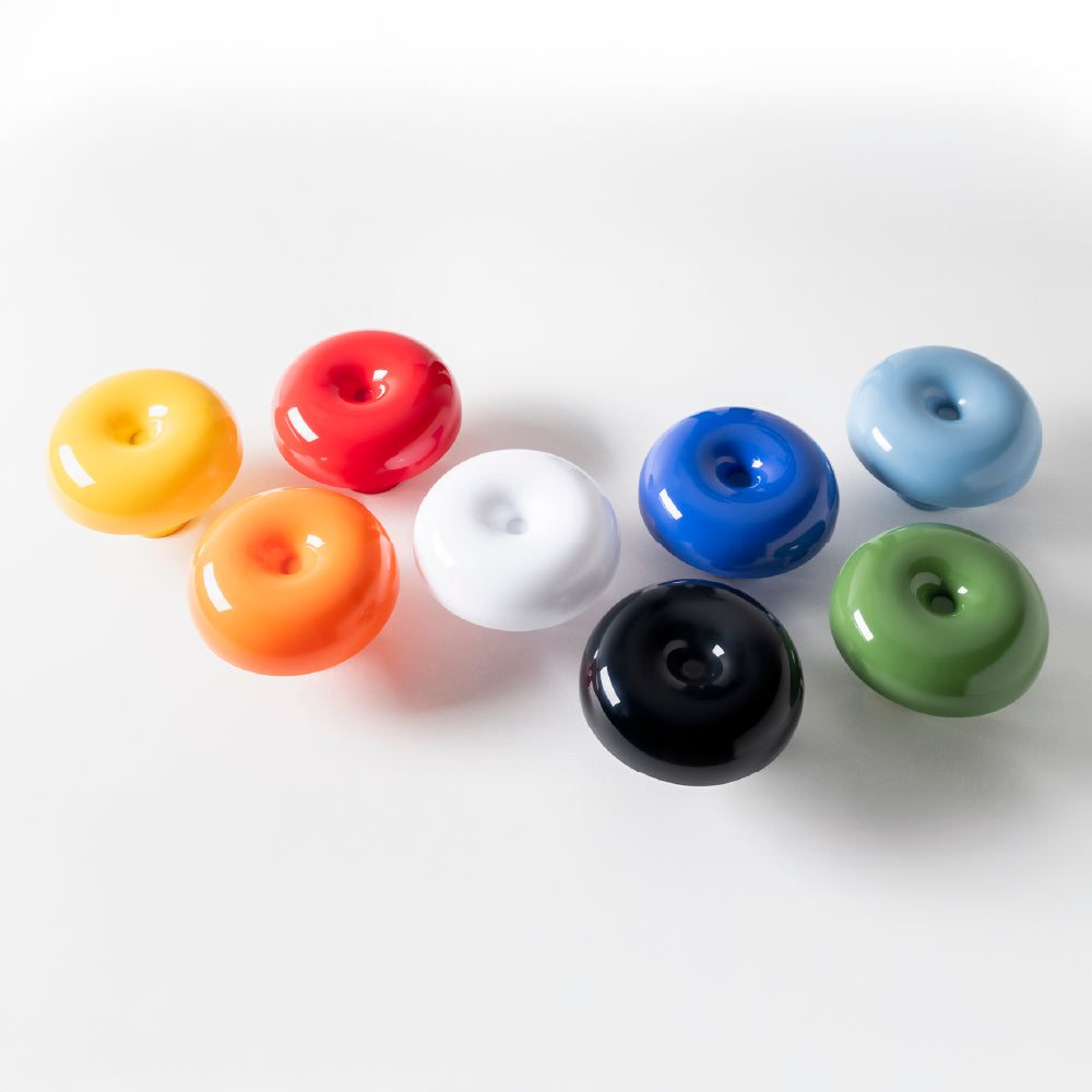 Artemide Nessino table lamp with curved mushroom diffuser showing 8 colors