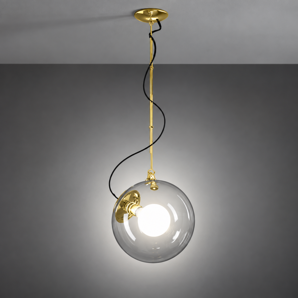Artemide Miconos pendant light side view with transparent globe in gold finish