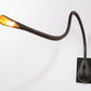 Modern Innermost Cobra wall sconce in rich brown leather, highlighting the black semi-gloss switch box.