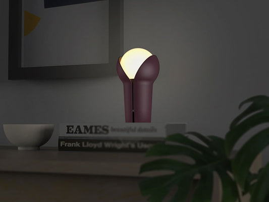 Innermost Bud rechargeable table lamp by Melissa Yip – Aubergine on a desk at night