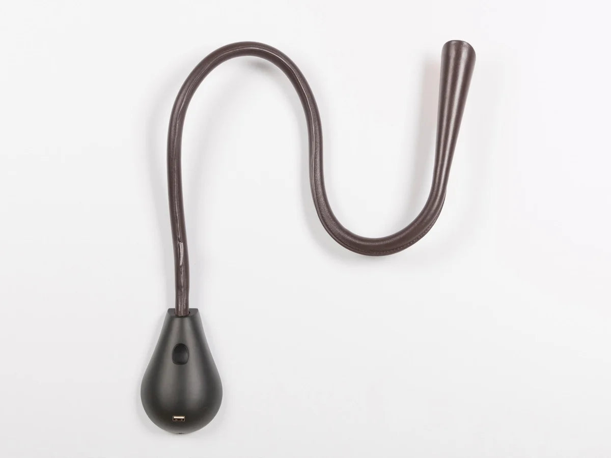 Close-up of Cobra LED wall lamp with brown leather flexible stem and gold inner hood, perfect for bedside reading.