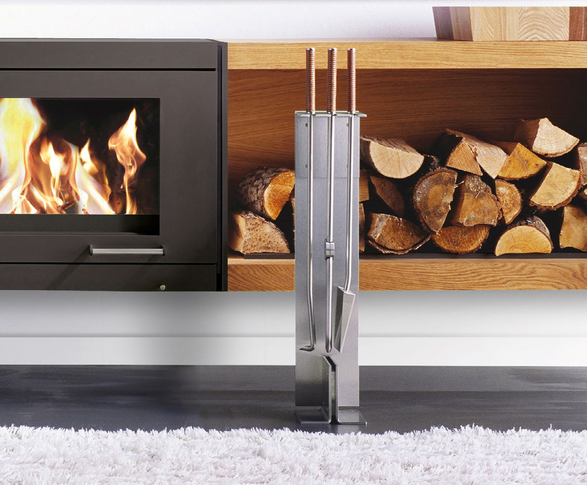 Conmoto Peter Maly fireside tools on floor stand beside a wood stove