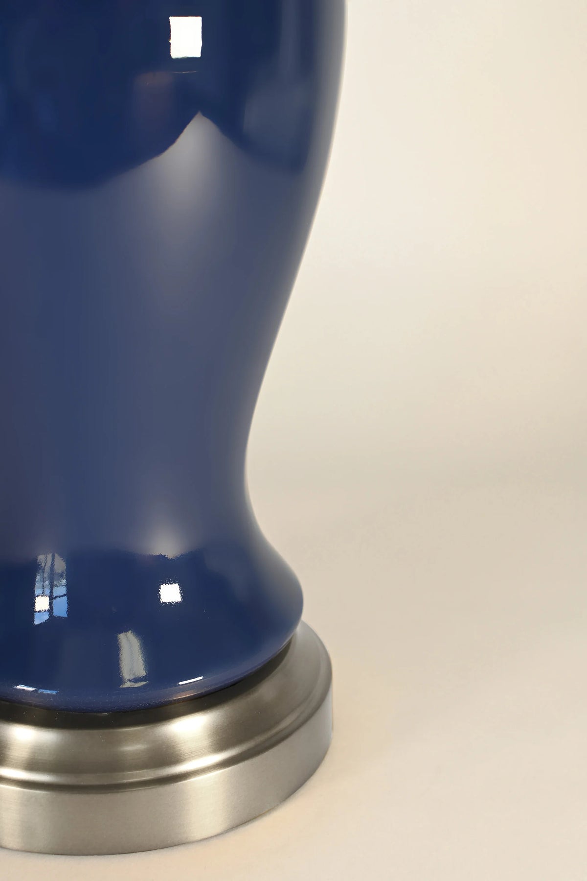 Close-up of midnight blue ceramic glaze and brushed nickel base on Elijah lamp