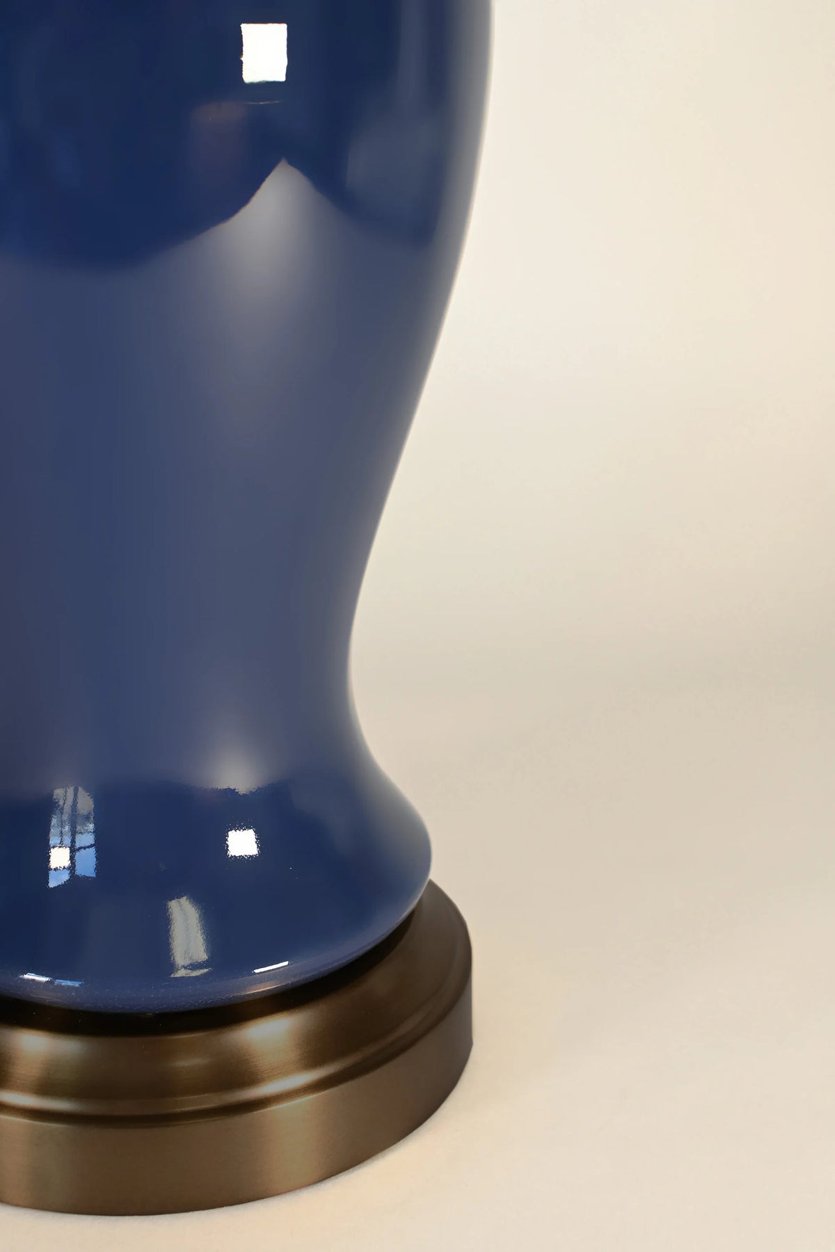 Close-up of midnight blue ceramic glaze and dark antique brass Elijah lamp base